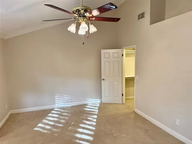 a view of a chandelier fan and refrigerator in a room