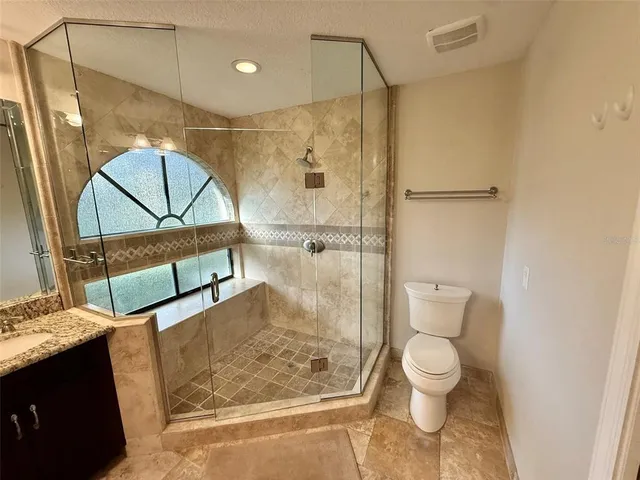 a bathroom with a toilet a sink and shower