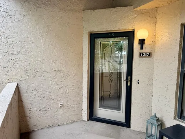 a view of a bathroom that has a glass door and shower