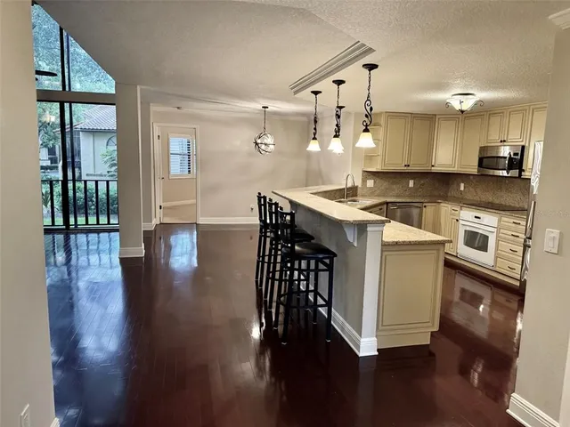 a kitchen with stainless steel appliances granite countertop a stove and a refrigerator