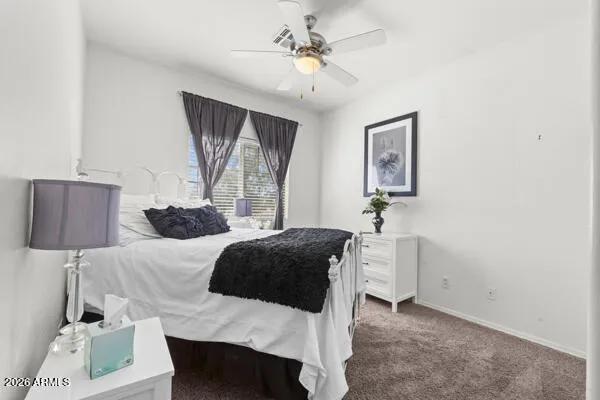 a bedroom with a bed and a potted plant