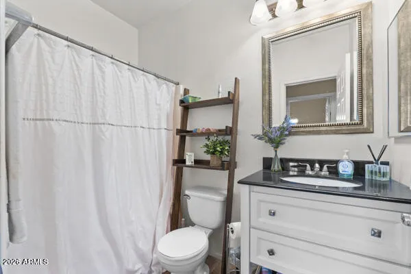 a bathroom with a toilet a sink and a mirror