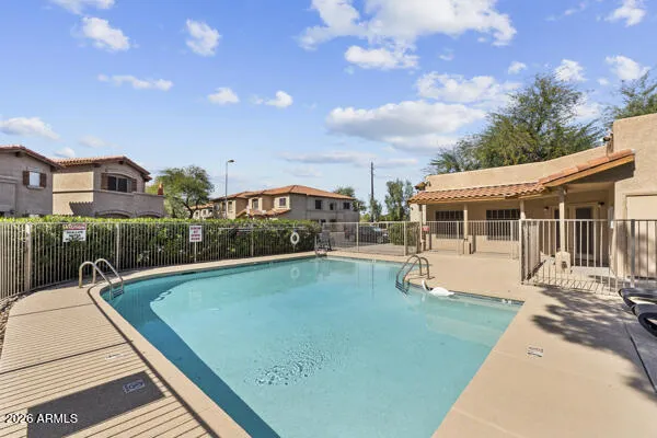 a view of a house with swimming pool and sitting area