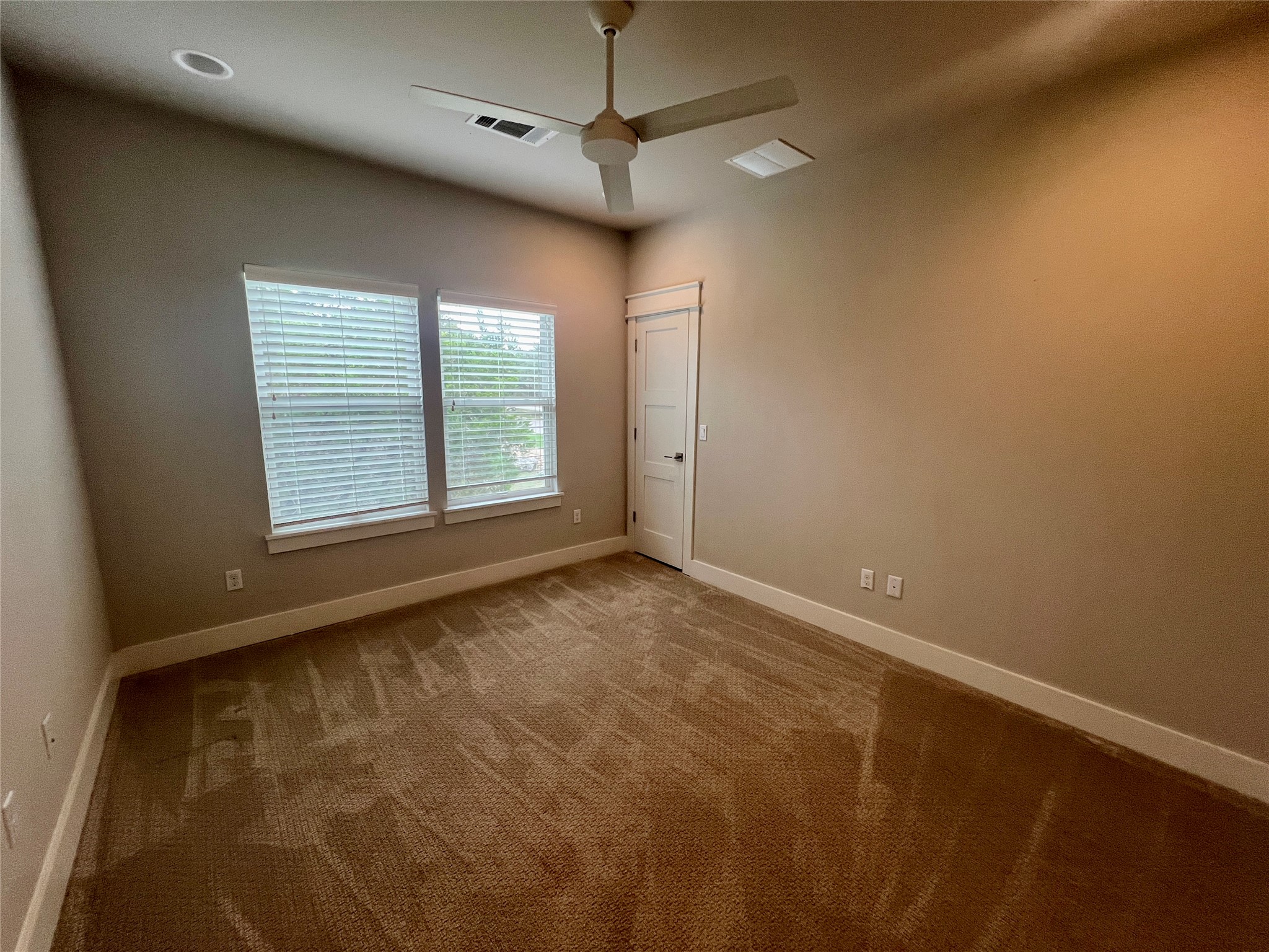 6515 Davis Lane, Unit 10 Austin, TX 78749 - Photo 18 of 22 A quiet retreat with plush carpeting, two windows, and a modern ceiling fan.
