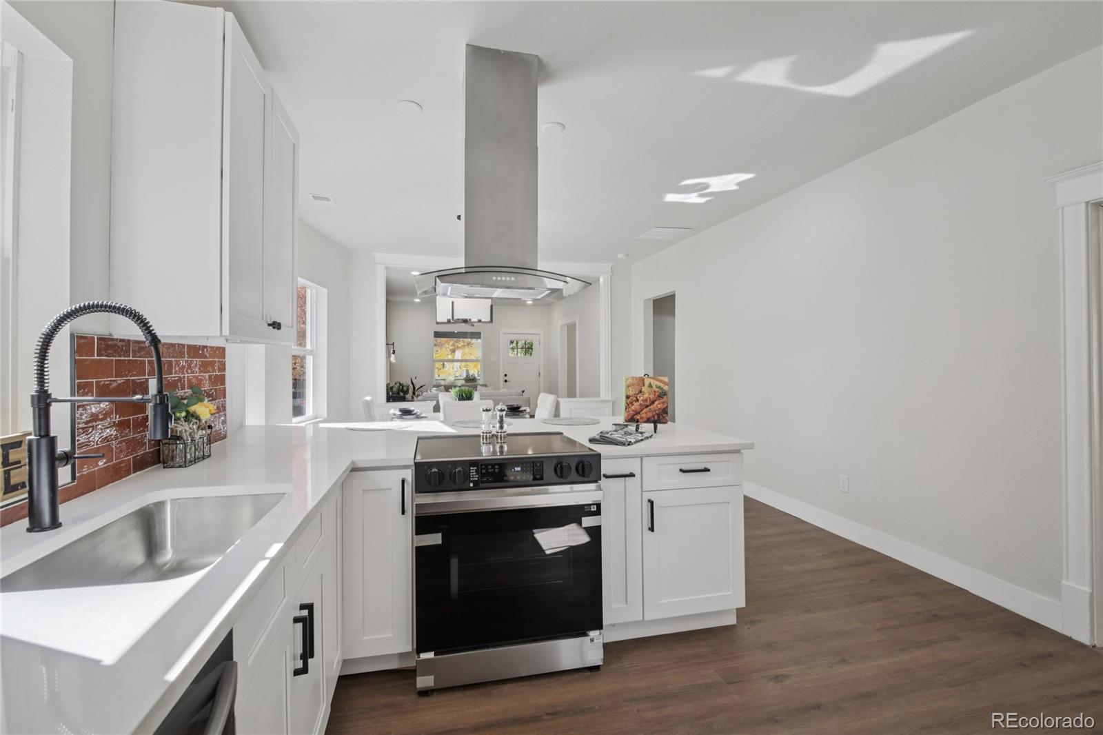 2342 Dexter Street Denver, CO 80207 - Photo 14 of 50 a kitchen with a stove and a sink