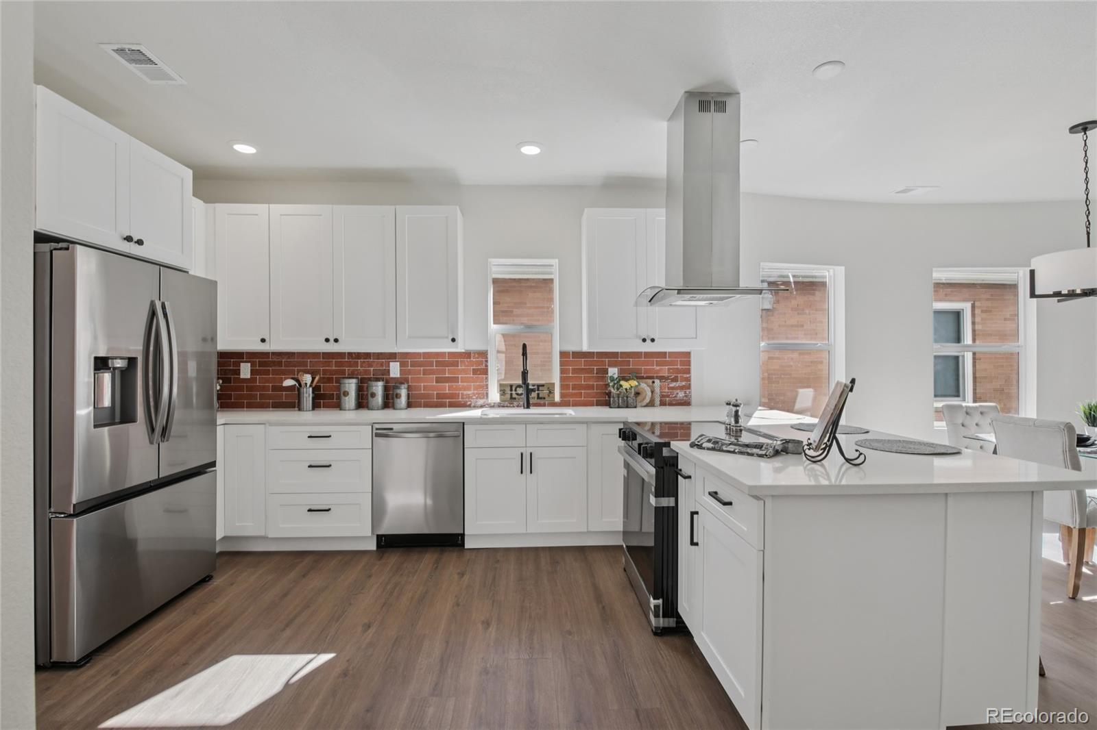 2342 Dexter Street Denver, CO 80207 - Photo 15 of 50 a kitchen with a sink stove cabinets and refrigerator