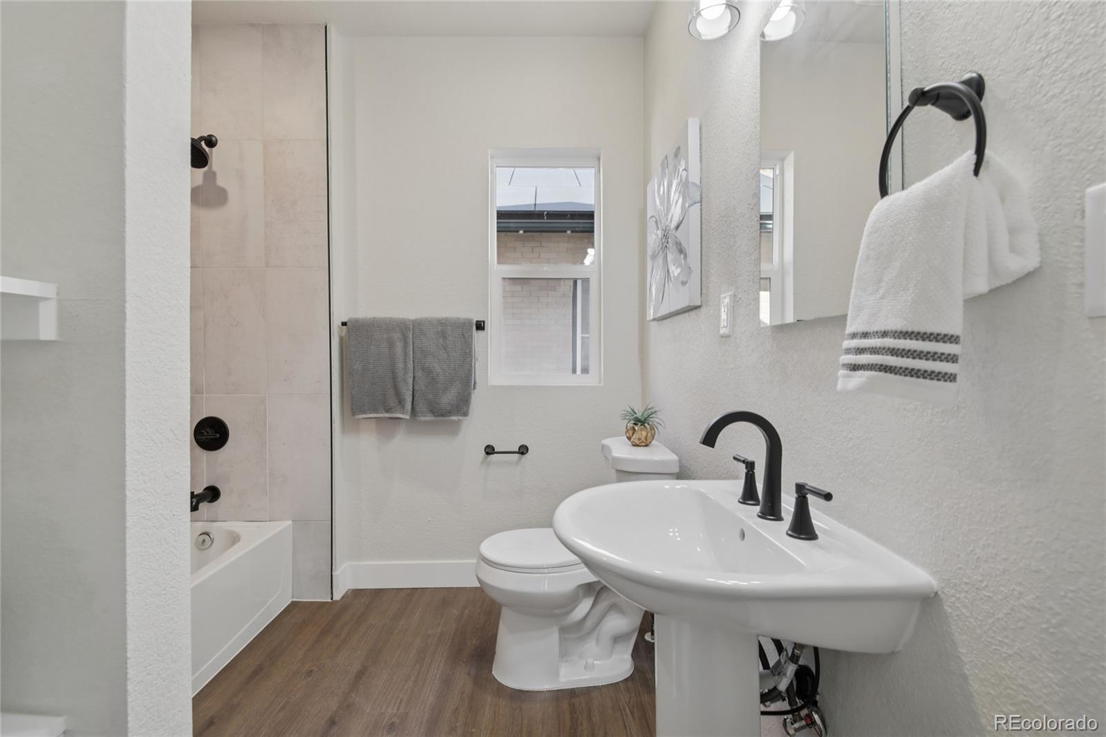 2342 Dexter Street Denver, CO 80207 - Photo 18 of 50 a bathroom with a sink toilet and shower