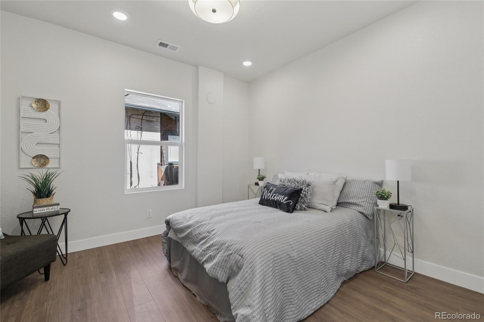 2342 Dexter Street Denver, CO 80207 - Photo 20 of 50 a bedroom with a bed and a table in it