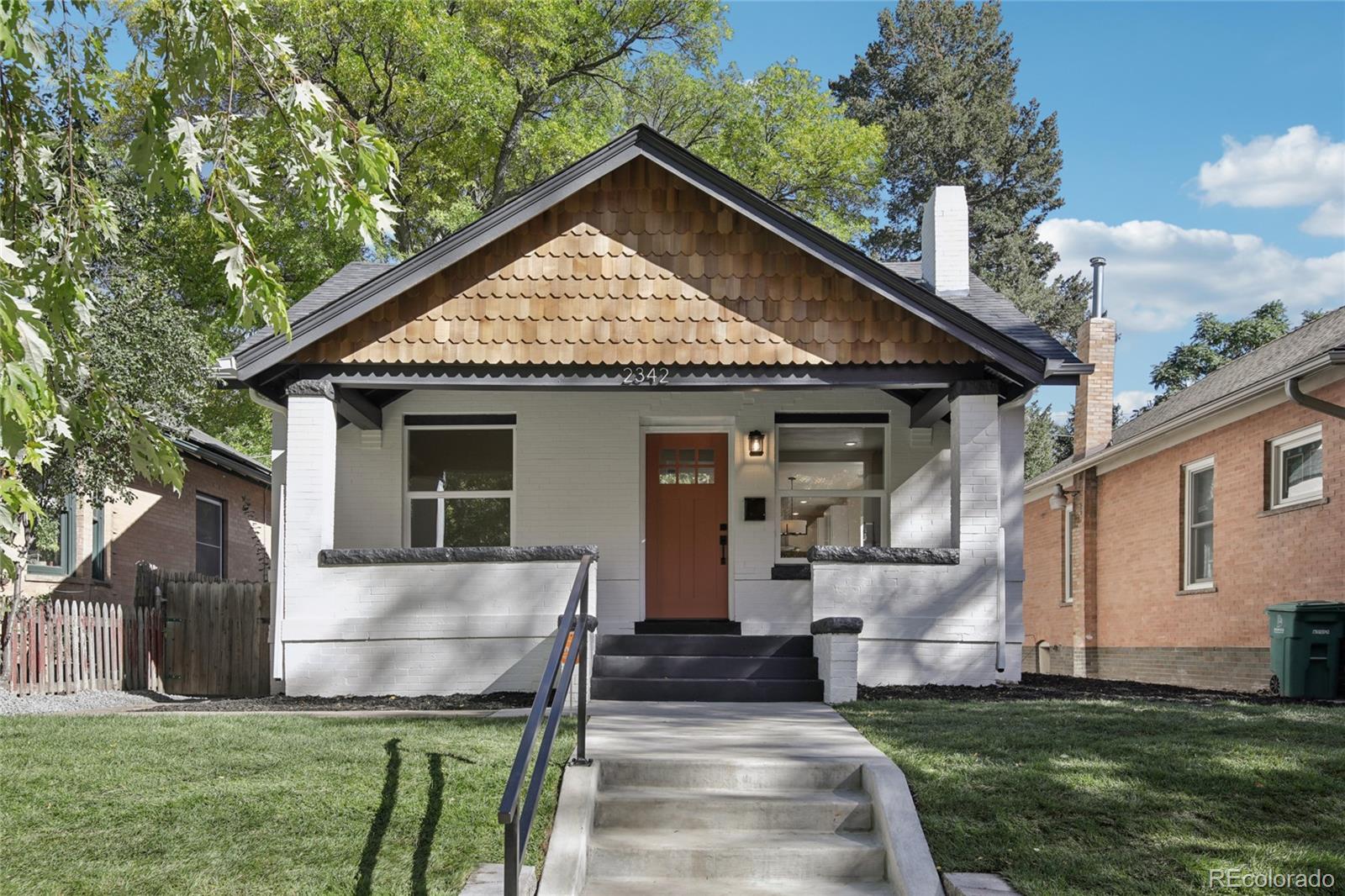 2342 Dexter Street Denver, CO 80207 - Photo 2 of 50 a front view of a house with a yard