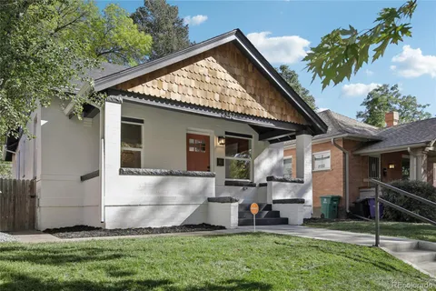 a front view of house with a garden