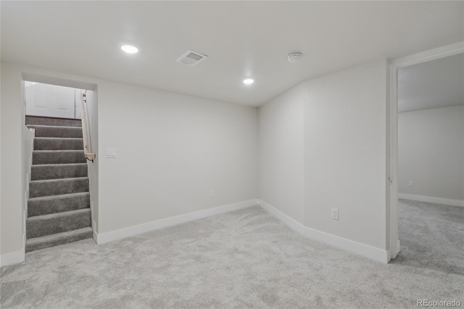 2342 Dexter Street Denver, CO 80207 - Photo 31 of 50 a view of an empty room with a kitchen