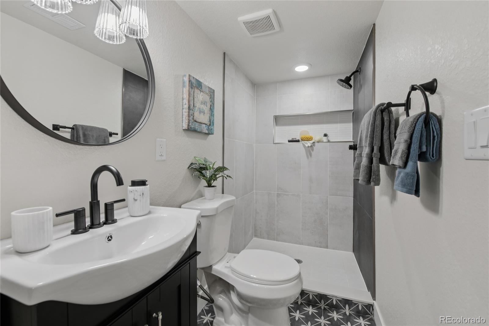 2342 Dexter Street Denver, CO 80207 - Photo 32 of 50 a bathroom with a sink toilet and shower