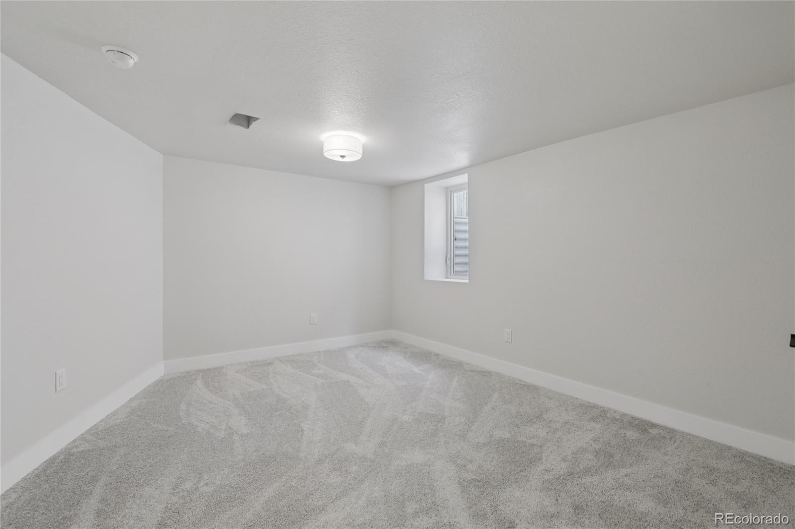 2342 Dexter Street Denver, CO 80207 - Photo 33 of 50 an empty room with a window