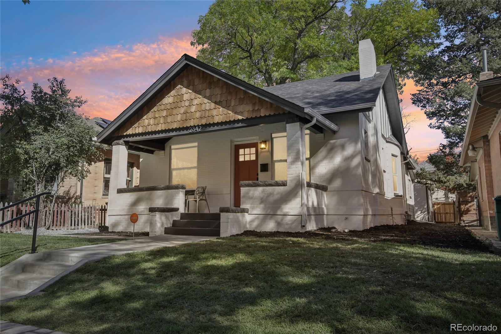 2342 Dexter Street Denver, CO 80207 - Photo 40 of 50 a front view of house with yard and green space