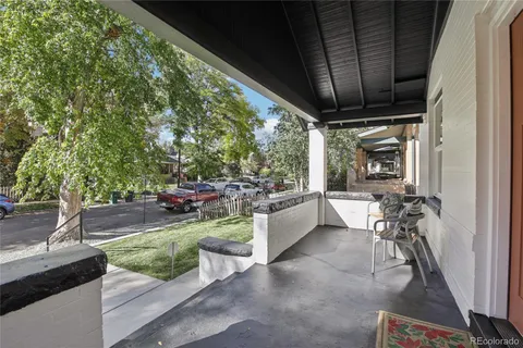 a view of a porch with furniture and a backyard