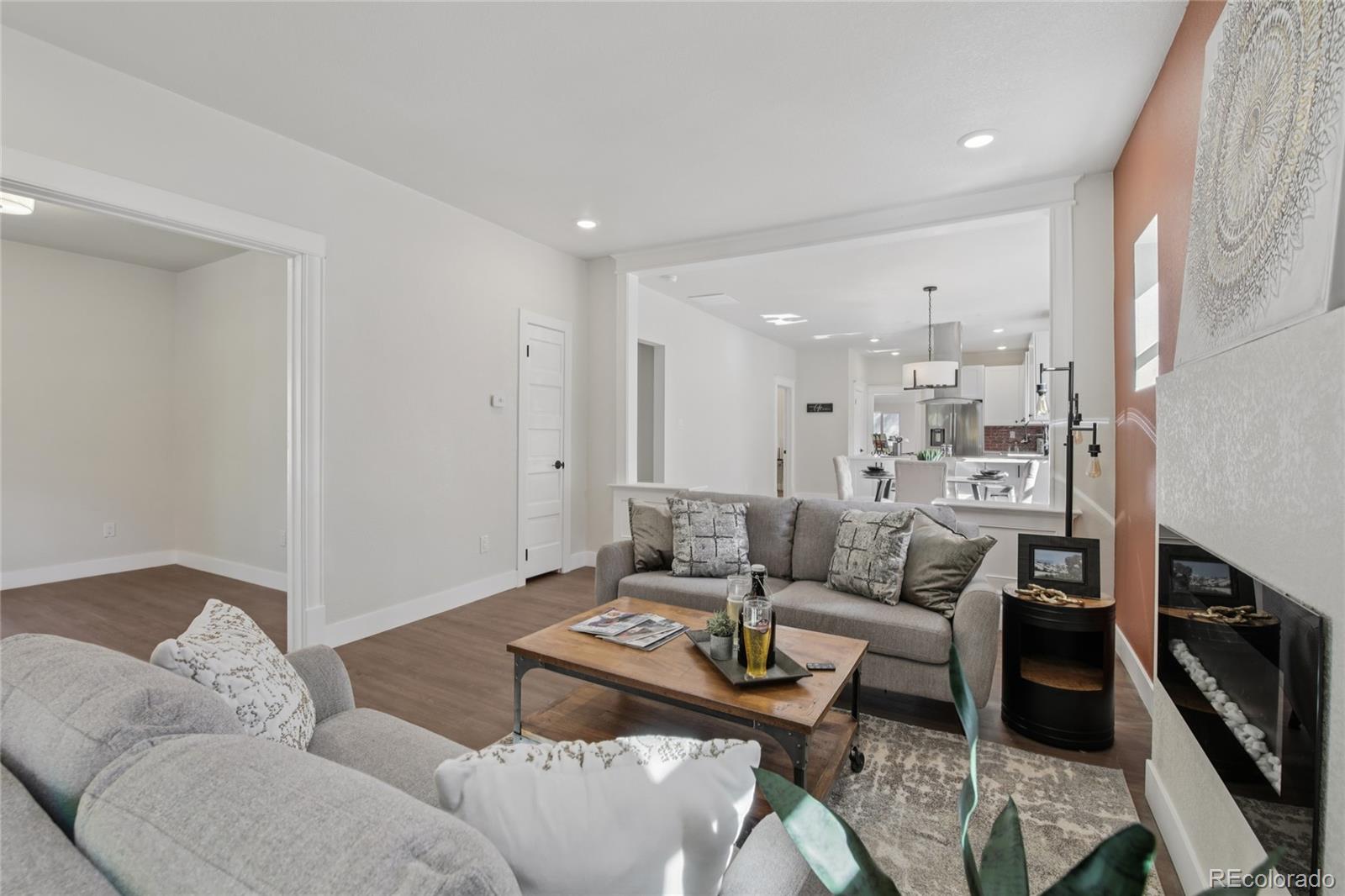 2342 Dexter Street Denver, CO 80207 - Photo 7 of 50 a living room with furniture and a flat screen tv