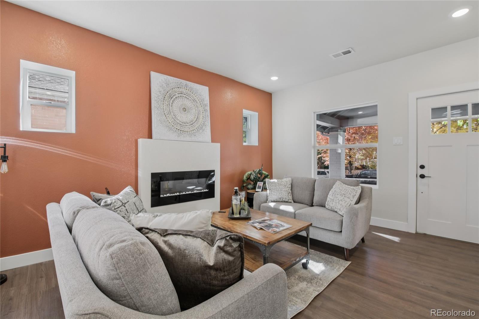 2342 Dexter Street Denver, CO 80207 - Photo 9 of 50 a living room with furniture and a fireplace