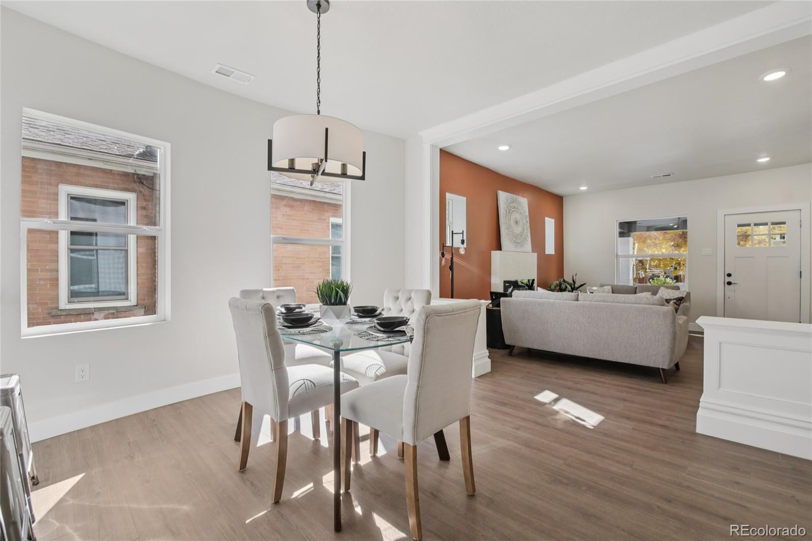 2342 Dexter Street Denver, CO 80207 - Photo 10 of 50 a living room with furniture and a chandelier