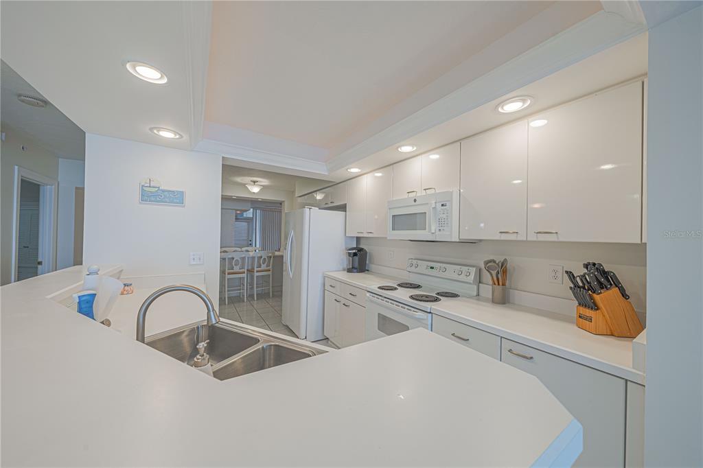 4575 South Atlantic Avenue, Unit 6607 Ponce Inlet, FL 32127 - Photo 12 of 48 a kitchen with stainless steel appliances granite countertop a sink a stove and cabinets