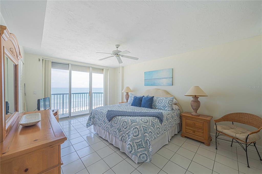 4575 South Atlantic Avenue, Unit 6607 Ponce Inlet, FL 32127 - Photo 17 of 48 a bedroom with a bed and large window