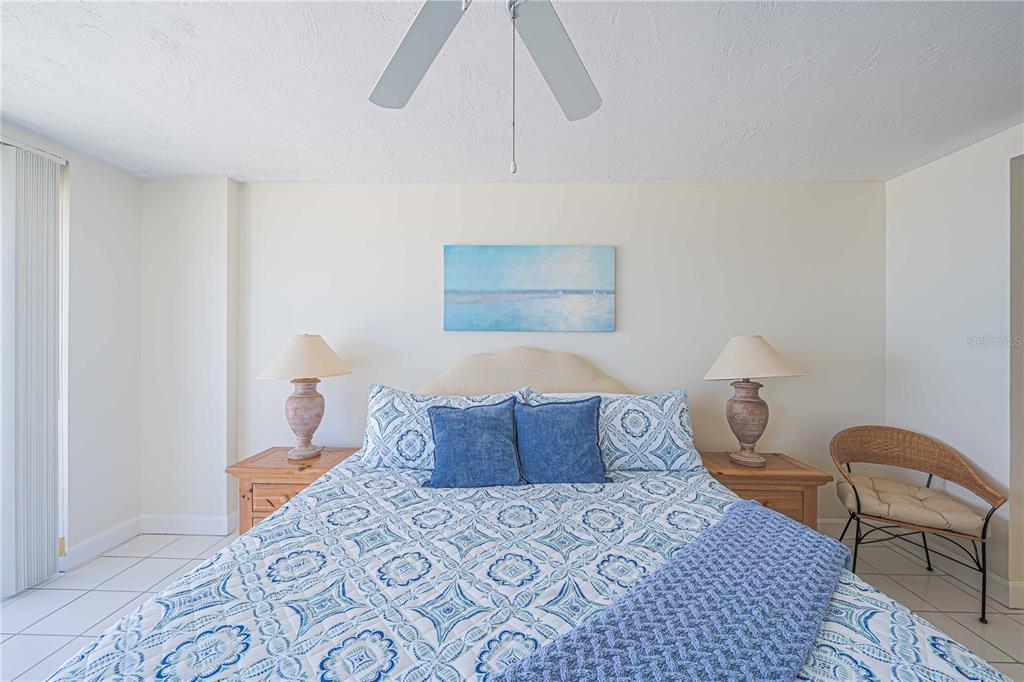 4575 South Atlantic Avenue, Unit 6607 Ponce Inlet, FL 32127 - Photo 19 of 48 a bedroom with a bed and a lamp on dresser