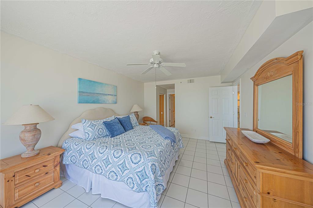 4575 South Atlantic Avenue, Unit 6607 Ponce Inlet, FL 32127 - Photo 20 of 48 a bedroom with a large bed and a dresser