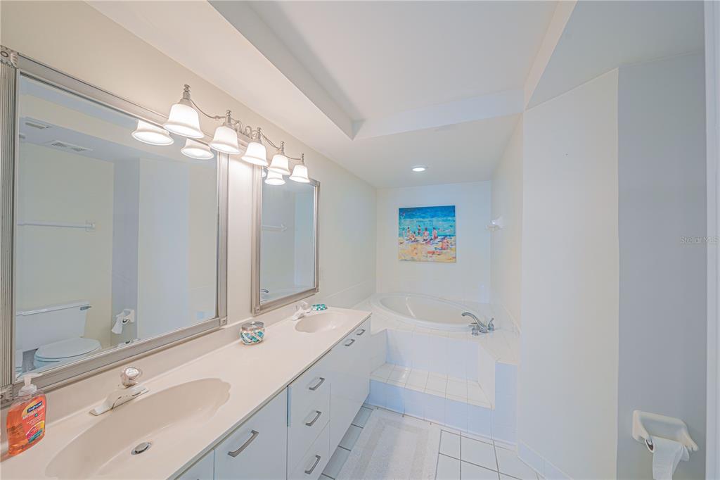 4575 South Atlantic Avenue, Unit 6607 Ponce Inlet, FL 32127 - Photo 22 of 48 a bathroom with a double vanity sink mirror and shower