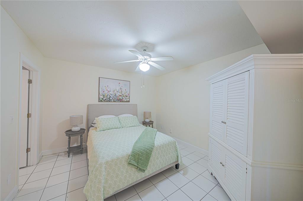 4575 South Atlantic Avenue, Unit 6607 Ponce Inlet, FL 32127 - Photo 25 of 48 a bedroom with a bed and a ceiling fan