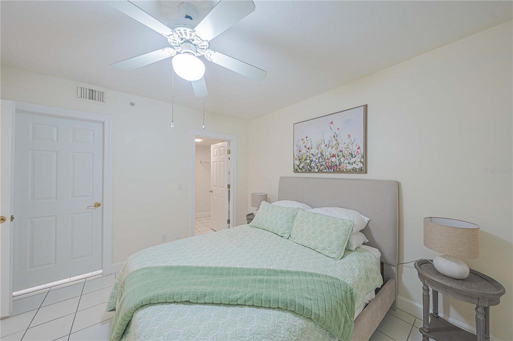 4575 South Atlantic Avenue, Unit 6607 Ponce Inlet, FL 32127 - Photo 26 of 48 a bedroom with a bed and a chandelier