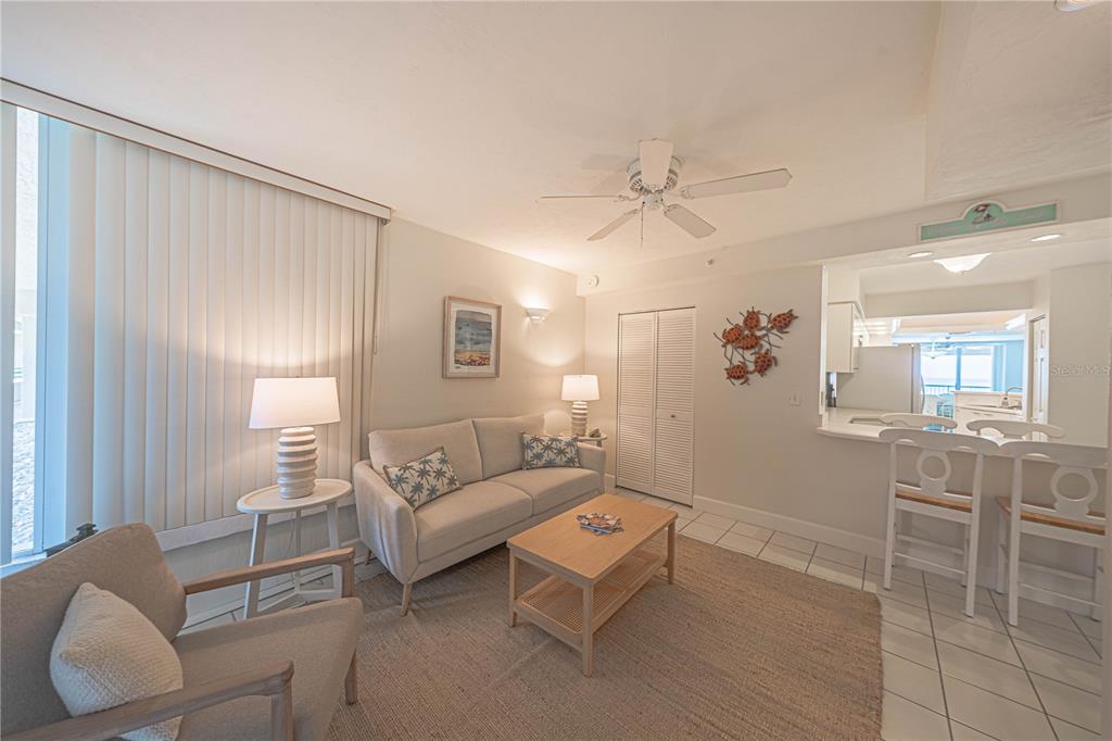 4575 South Atlantic Avenue, Unit 6607 Ponce Inlet, FL 32127 - Photo 30 of 48 a living room with furniture and a chandelier