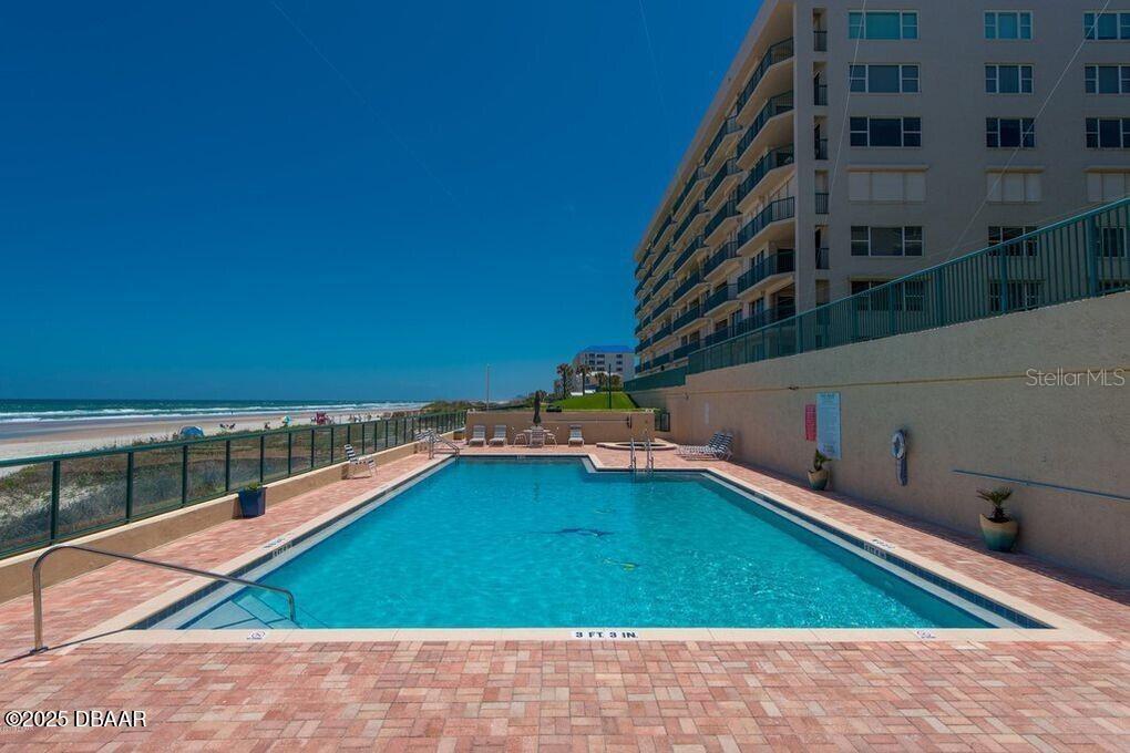 4575 South Atlantic Avenue, Unit 6607 Ponce Inlet, FL 32127 - Photo 40 of 48 a small pool with lawn chairs