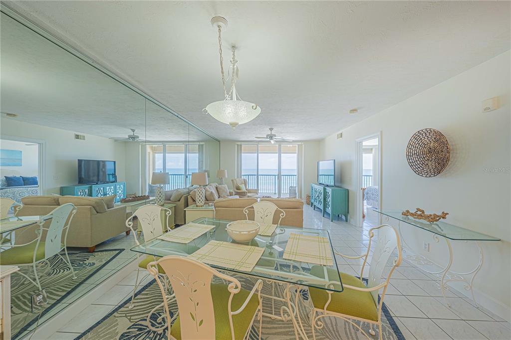 4575 South Atlantic Avenue, Unit 6607 Ponce Inlet, FL 32127 - Photo 10 of 48 a living room with furniture and a chandelier