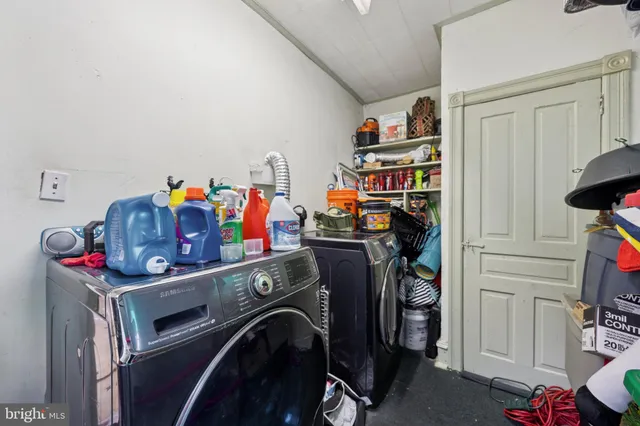 a utility room with dryer washer and closet