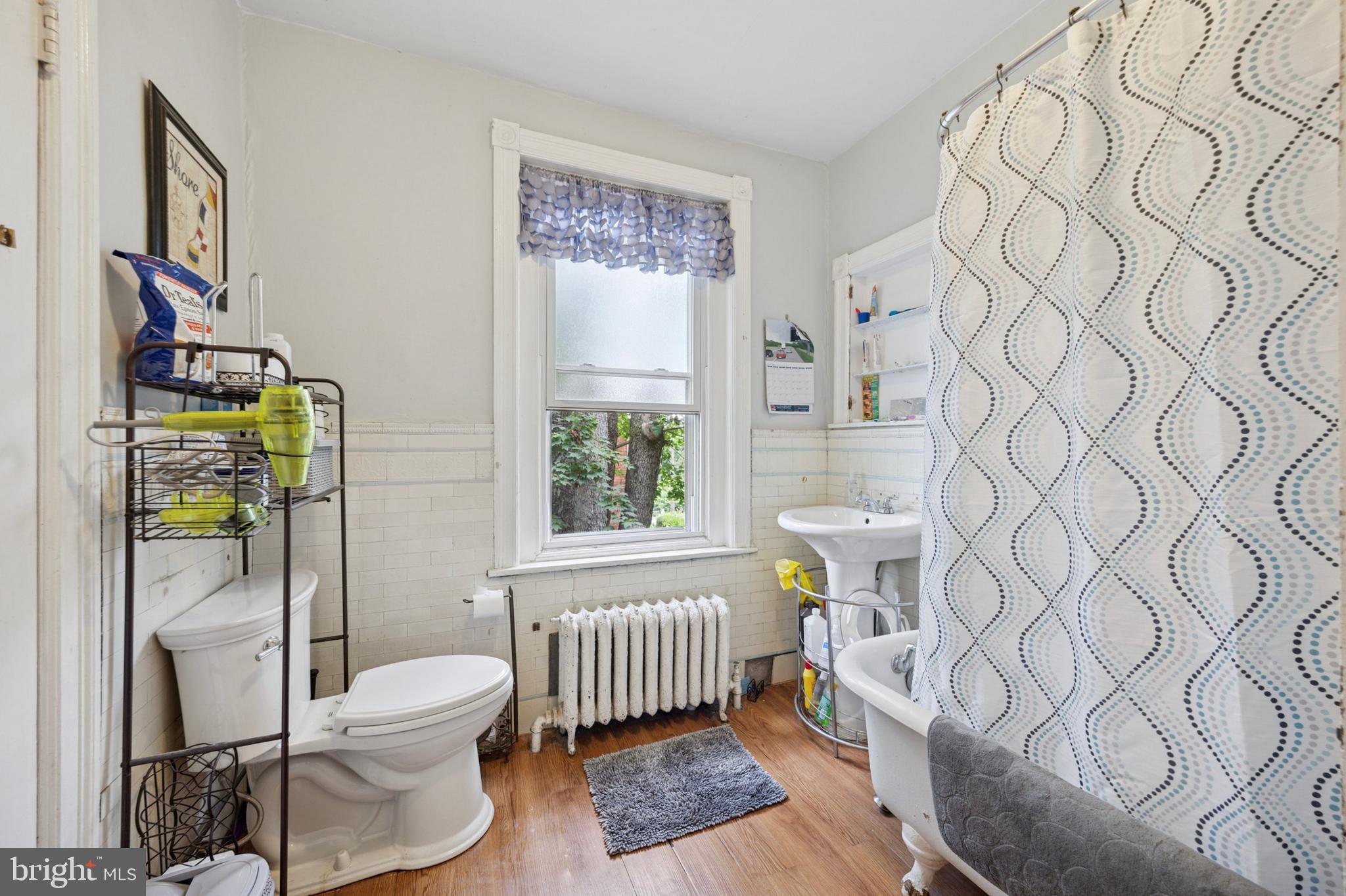 512 Crest Avenue Elkins Park, PA 19027 - Photo 16 of 24 a bathroom with a toilet and a shower curtain