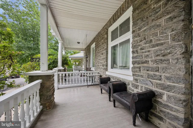a balcony with furniture and a gate