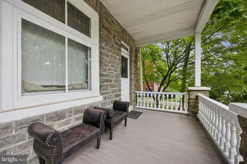 a living room with patio furniture and a floor to ceiling window