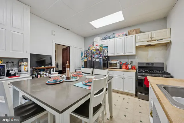 a kitchen with sink cabinets and stove top oven
