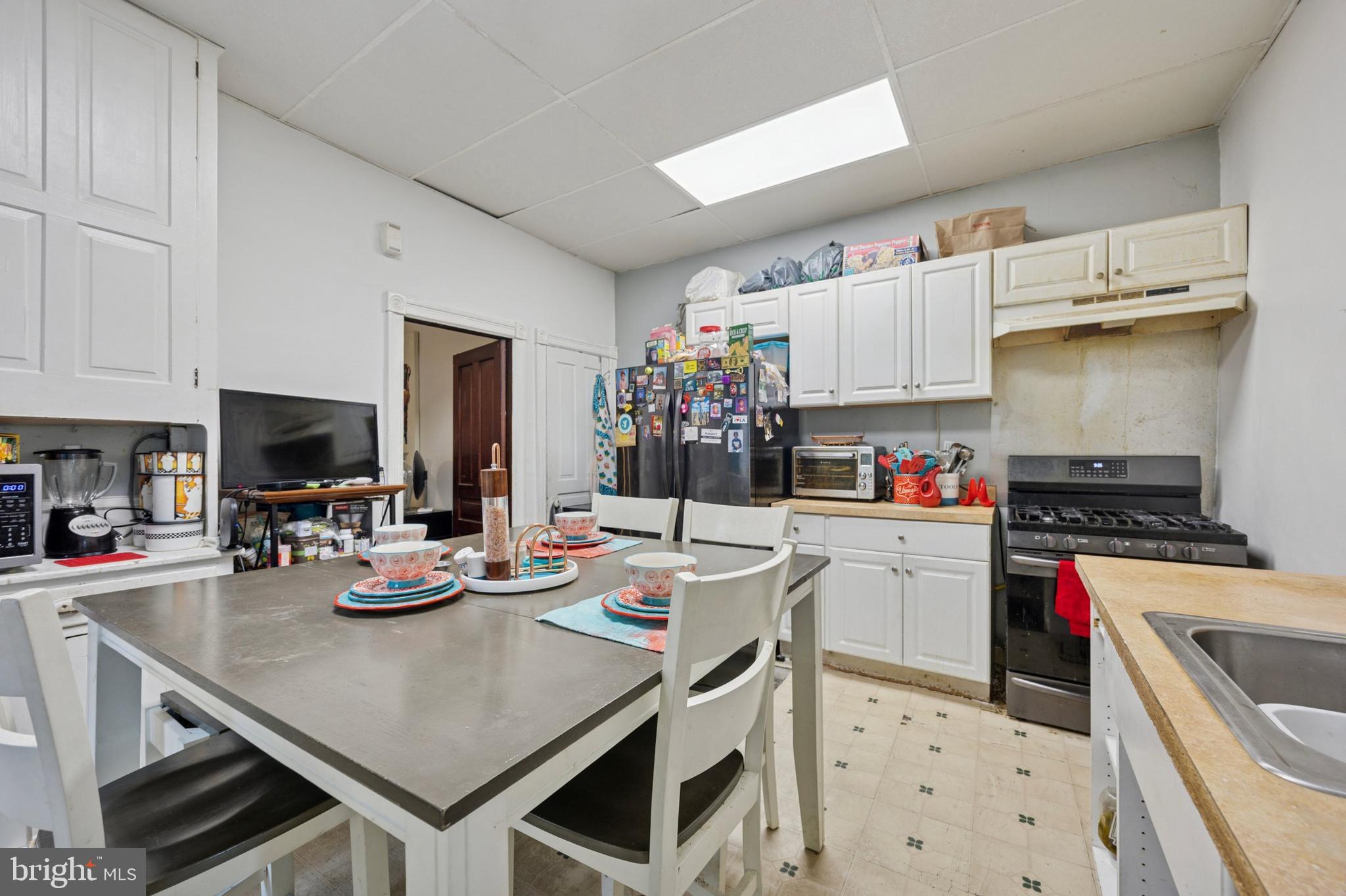 512 Crest Avenue Elkins Park, PA 19027 - Photo 9 of 24 a kitchen with sink cabinets and stove top oven