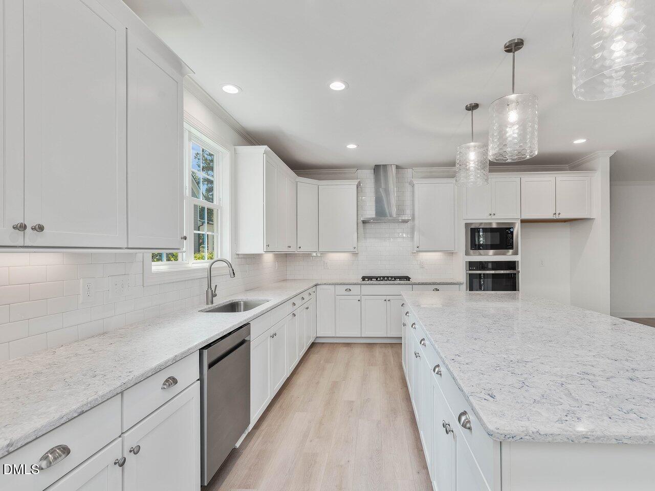 249 High Ridge Lane Pittsboro, NC 27312 - Photo 12 of 65 a large kitchen with stainless steel appliances kitchen island granite countertop a sink and cabinets