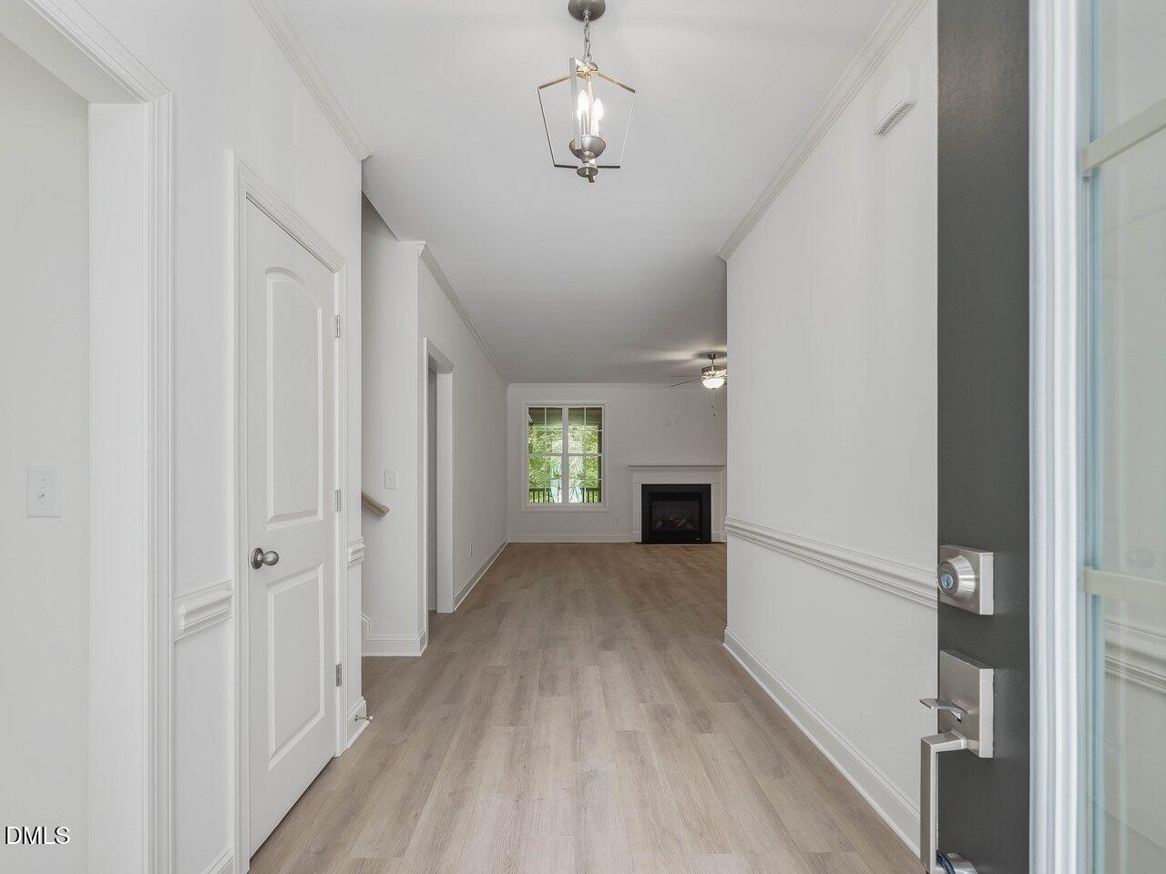 249 High Ridge Lane Pittsboro, NC 27312 - Photo 3 of 65 a view of a hallway with wooden floor and staircase