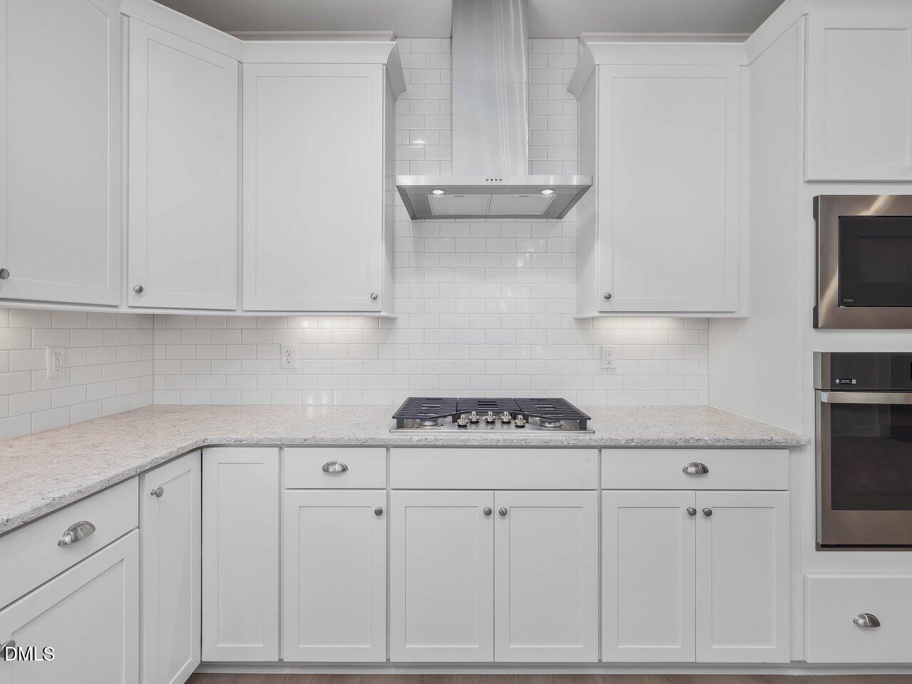 249 High Ridge Lane Pittsboro, NC 27312 - Photo 8 of 65 a kitchen with white cabinets and a stove