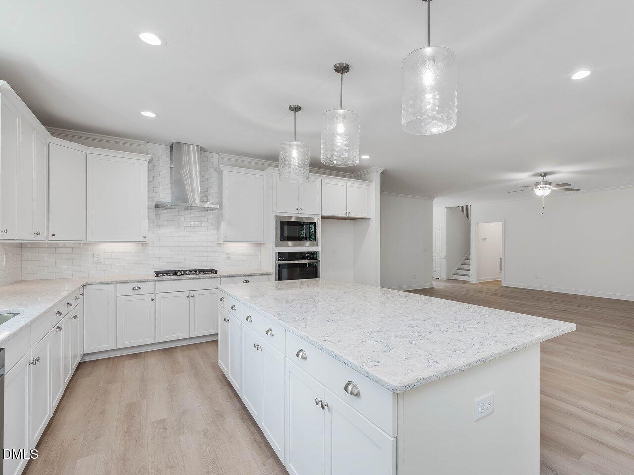 249 High Ridge Lane Pittsboro, NC 27312 - Photo 10 of 65 a kitchen with granite countertop cabinets a sink dishwasher and a stove with wooden floor