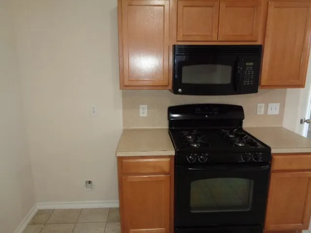 a kitchen with a stove and a microwave