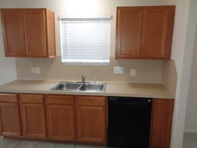 a kitchen with a sink cabinets and window