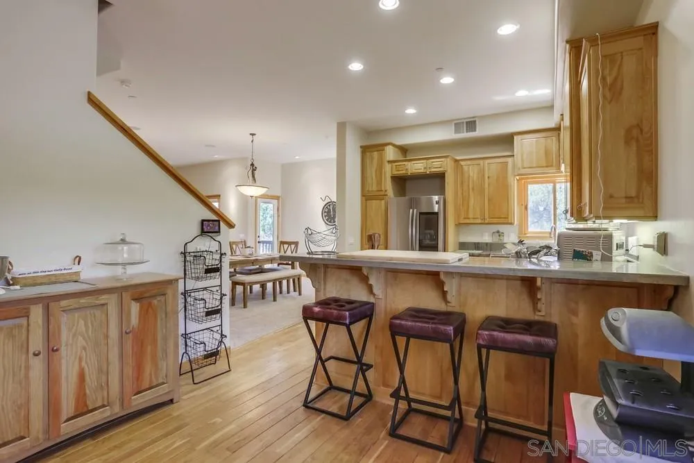 753 Ridgewood Drive Julian, CA 92036 - Photo 11 of 48 a kitchen with a table chairs sink and cabinets