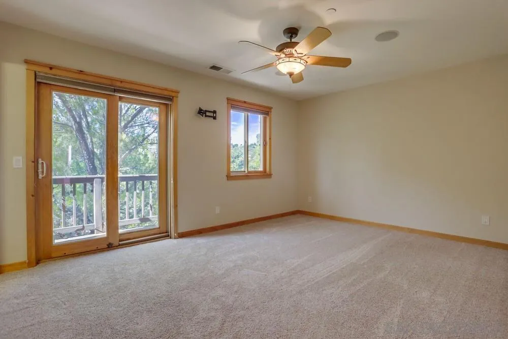 753 Ridgewood Drive Julian, CA 92036 - Photo 19 of 48 an empty room with chandelier fan and windows
