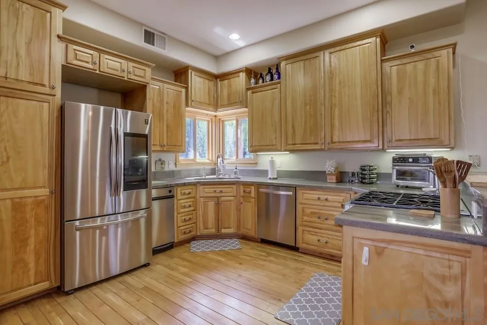 753 Ridgewood Drive Julian, CA 92036 - Photo 9 of 48 a kitchen with stainless steel appliances granite countertop a refrigerator a stove and a sink