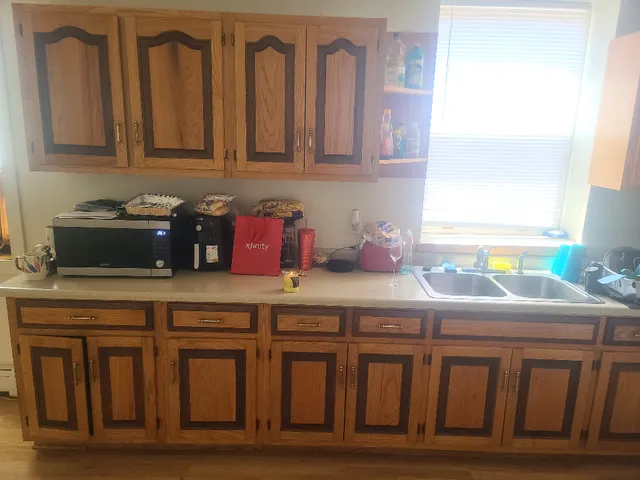 a kitchen with granite countertop a sink a stove and cabinets