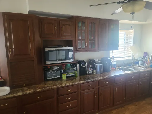 a kitchen with granite countertop stainless steel appliances and cabinets