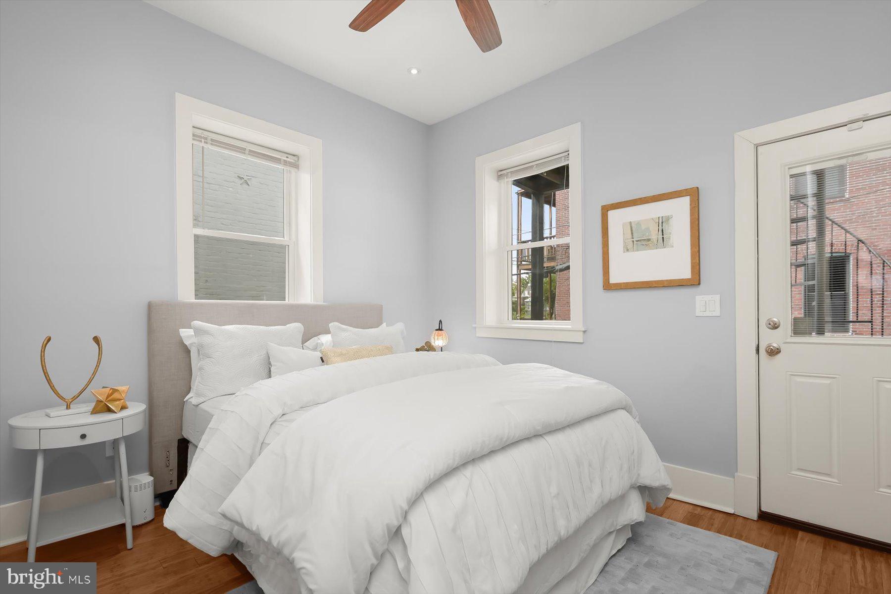 2128 1st Street Northwest, Unit 1 Washington, DC 20001 - Photo 13 of 36 a bedroom with a bed and a window